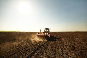 Tractor with seeder sowing crops at soybean farm - NOF00511