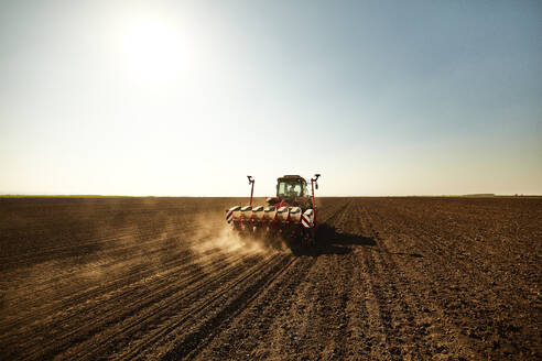 Tractor with seeder sowing crops at soybean farm - NOF00511