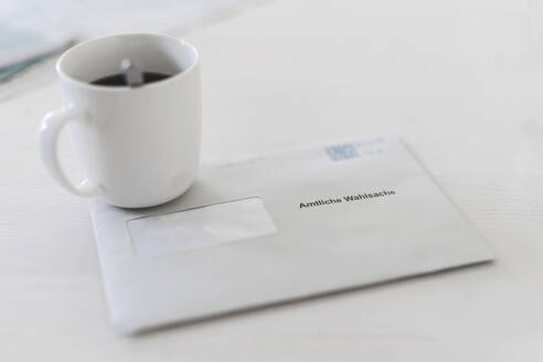 Postal vote envelope with coffee cup on table - CHPF00855