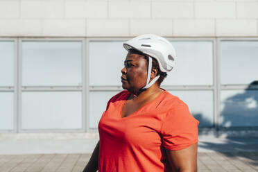 Frau mit Fahrradhelm an einem sonnigen Tag - MEUF05505
