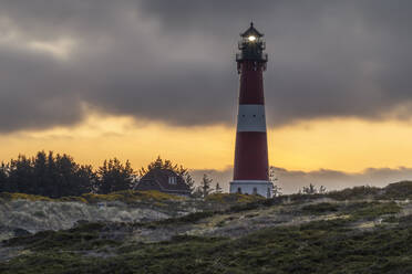 Germany, Schleswig-Holstein, Hornum, Hornum Lighthouse at cloudy dusk - KEBF02265