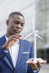 Young engineer examining wind turbine model - IFRF01646