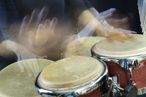 Hands of woman playing bongo - RNF01347