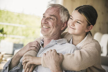 Happy senior man with granddaughter at home - UUF26152