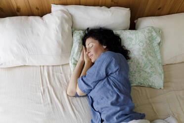 Woman with eyes closed resting in bed at home - TYF00158
