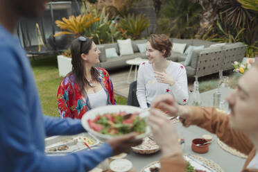 Glückliche Freunde genießen das Mittagessen am Terrassentisch - CAIF32491