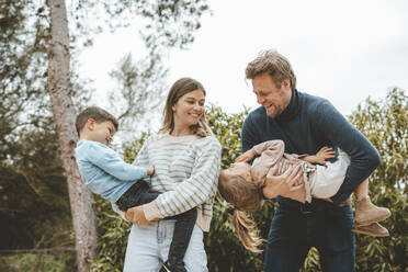 Playful parents with daughter and son in nature - JOSEF09509