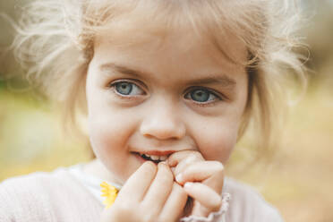 Cute blond girl with yellow flower - JOSEF09545