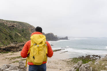 Mann mit Rucksack schaut auf Aussicht - JCCMF06326