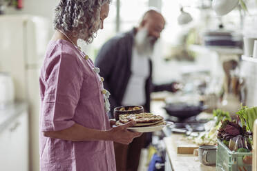 Senior couple cooking in kitchen - CAIF32626