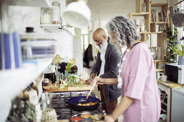 Couple cooking at kitchen stove - CAIF32641