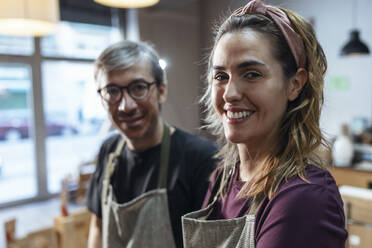 Happy store owner with colleague at organic market - JSRF02039