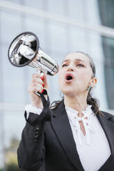 Mature businesswoman speaking through megaphone - IFRF01699