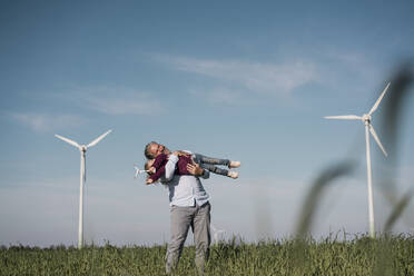 Glücklicher Mann mit Tochter auf einem Bauernhof an einem sonnigen Tag - MOEF04112