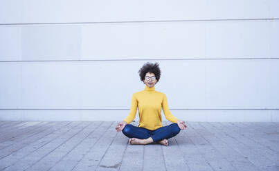 Young woman sitting cross legged by water in yoga position, eyes closed,  Philadelphia, Pennsylvania, USA - Stock Photo - Masterfile - Premium  Royalty-Free, Code: 614-08329279
