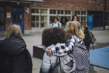 Junge geht mit Arm um Freund in Schulcampus - MASF30115