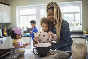 Mother and daughter baking in kitchen - CAIF32739