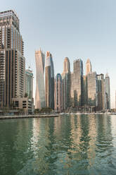 United Arab Emirates, Dubai, Dubai Marina with tall downtown skyscrapers in background - TAMF03356