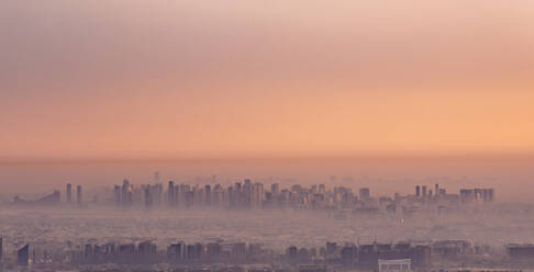 United Arab Emirates, Dubai, Panoramic view of city downtown at foggy dawn - TAMF03370