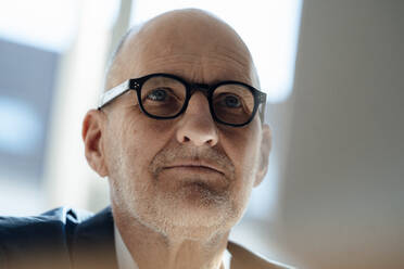 Senior businessman wearing eyeglasses in office - JOSEF09862