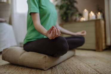 Woman practicing lotus position at home - HAPF03172