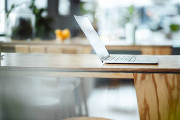 Laptop on table at coffee shop - JOSEF09942