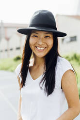 Happy beautiful woman wearing hat on sunny day - MEUF05950