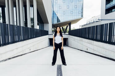 Young woman standing at driveway - MEUF05969