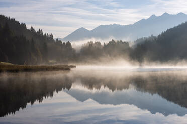Germany, Bavaria, Geroldsee lake at foggy morning - RUEF03689