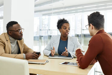 Young businesswoman discussing strategy with colleagues in office - DSHF00451