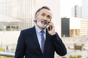 Mature businessman talking on mobile phone - OIPF02036