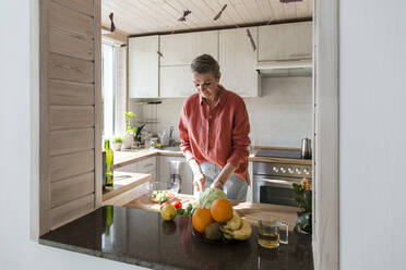 Woman preparing salad in kitchen at home - LLUF00562