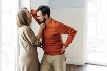 Cheerful couple standing together at home - VPIF06325