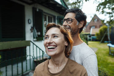 Cheerful woman with man in back yard - JOSEF10351