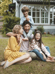 Cheerful family enjoying in back yard - JOSEF10497