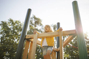 Girl playing at playground on sunny day - DWF00581