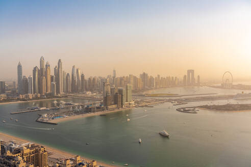 United Arab Emirates, Dubai, View of coastal city at sunset - TAMF03399