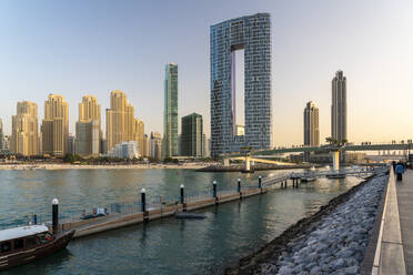 United Arab Emirates, Dubai, Dubai Marina with jetty in foreground and luxury hotel in background - TAMF03407