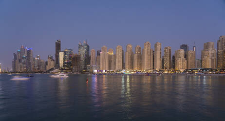 United Arab Emirates, Dubai, Skyline of coastal apartments at dusk - TAMF03416