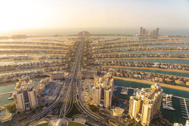 United Arab Emirates, Dubai, Elevated view of Palm Jumeirah archipelago at sunset - TAMF03421