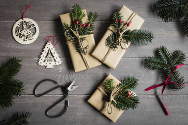 Studio shot of naturally wrapped Christmas presents decorated with spruce twigs - EVGF04003