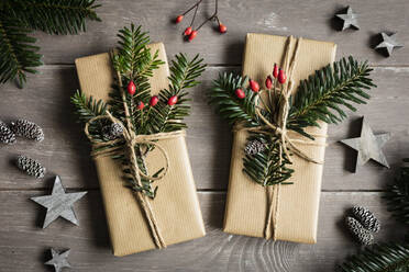 Studio shot of naturally wrapped Christmas presents decorated with spruce twigs - EVGF04006