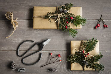 Studio shot of naturally wrapped Christmas presents decorated with spruce twigs - EVGF04010