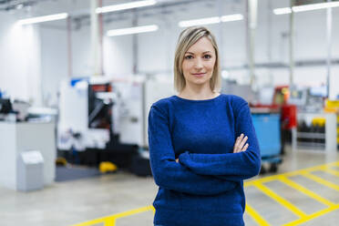 Portrait of confident businesswoman in factory - DIGF17973