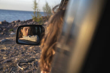 Reflection of woman in car mirror - VPIF06378