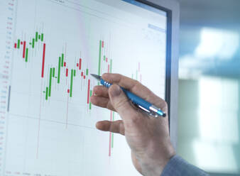 Händler, der im Büro am Computer Börsendaten analysiert - ABRF00982