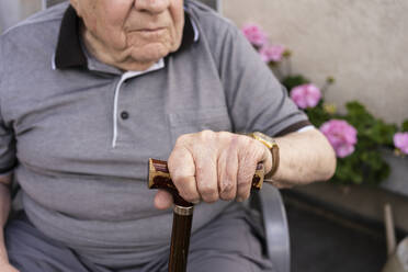 Hand eines älteren Mannes, der einen Gehstock hält - SVKF00285