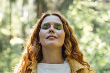 Young woman with small leaves on eyes - VPIF06543