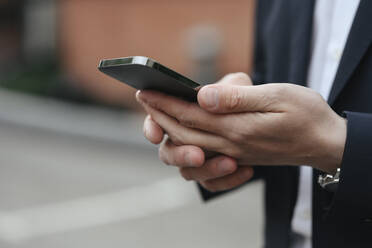 Hands of businessman using smart phone - EYAF01929