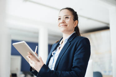 Businesswoman with tablet PC at work place - JOSEF10563